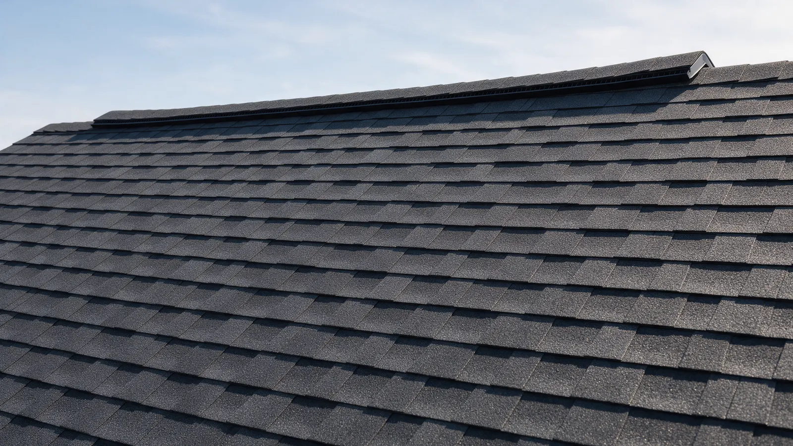 Architectural shingles meeting a brick chimney with step and counter flashing